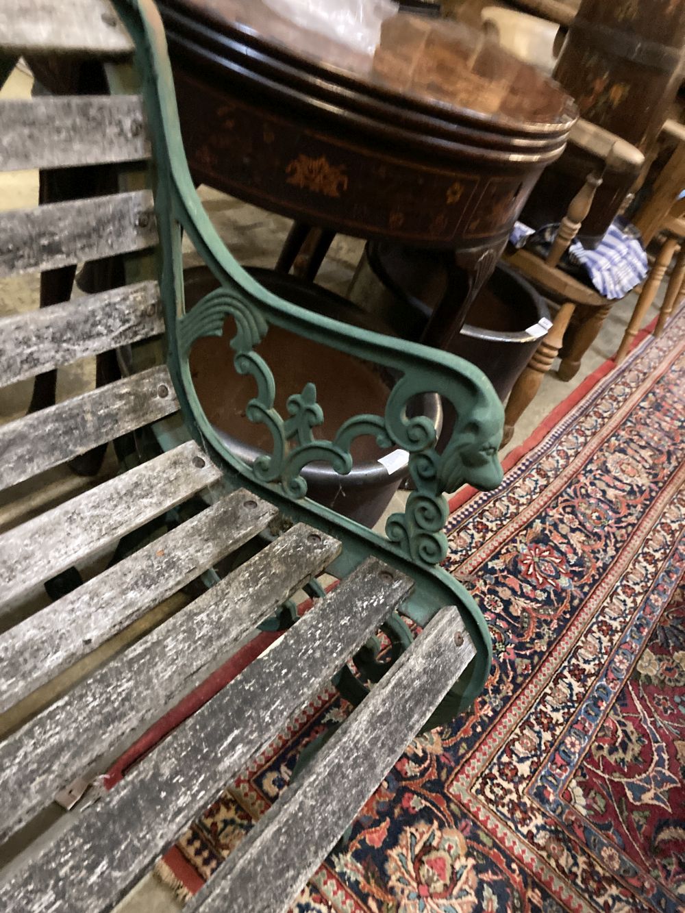 Four cast metal slatted wood garden armchairs and matching rectangular table, table 126 x 67cm, height 65cm